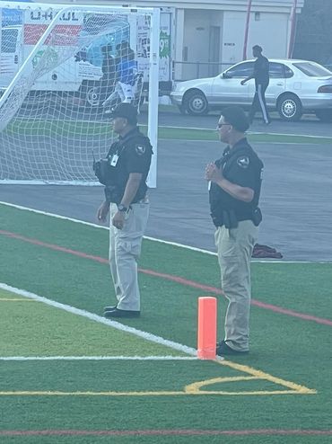 Security officials at soccer field sports event