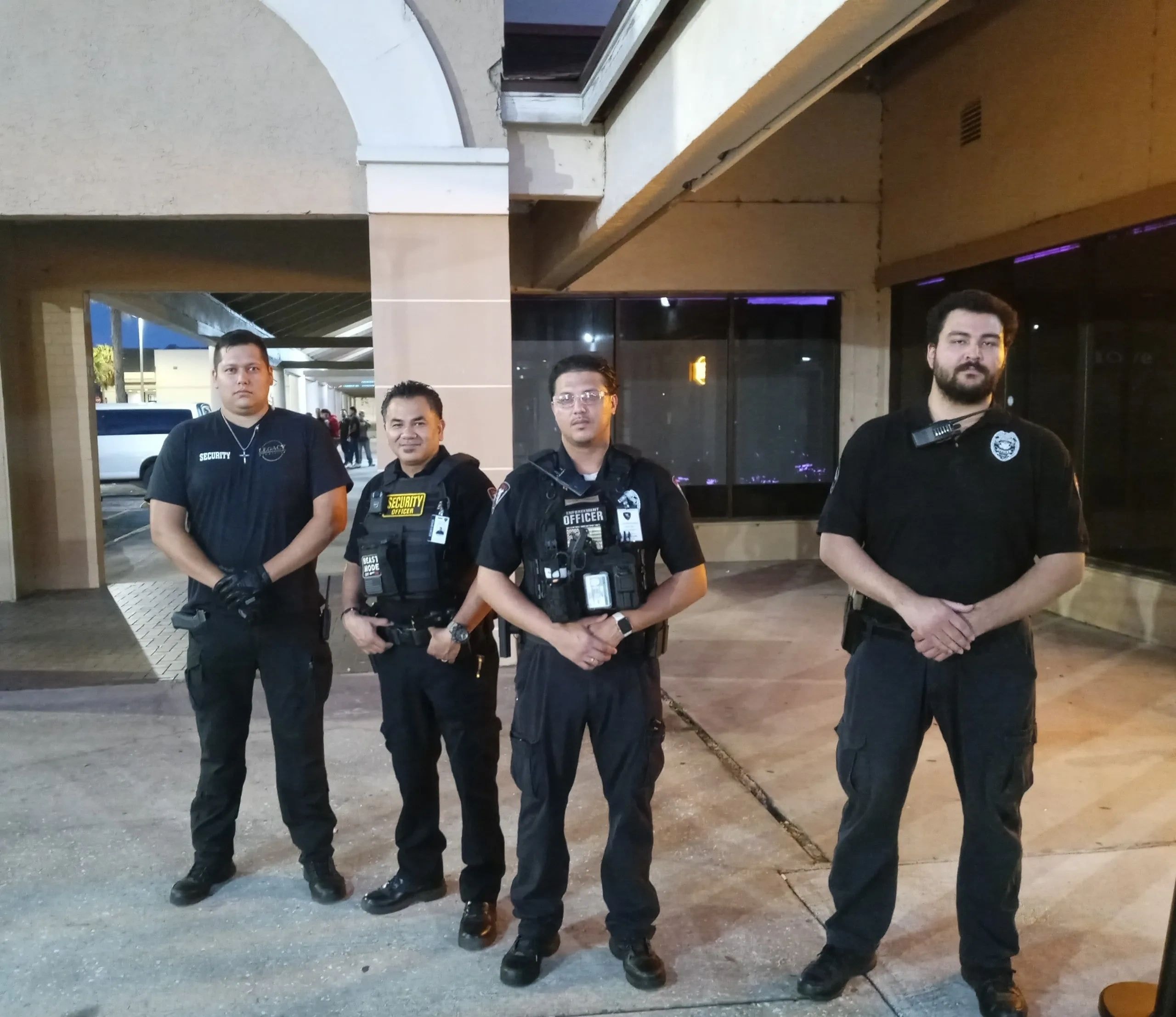 Four Level 3 Security guards standing in uniform in a corridor